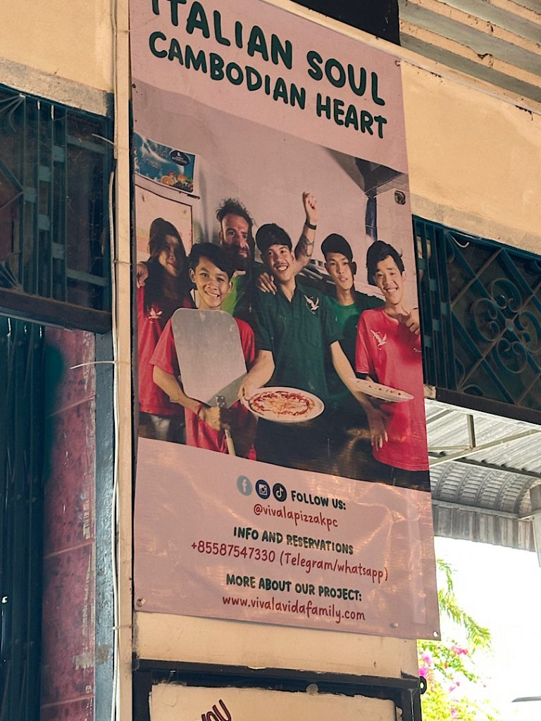 Es ist eine Plakat zu sehen, dass Werbung für Viva la Pizza macht.